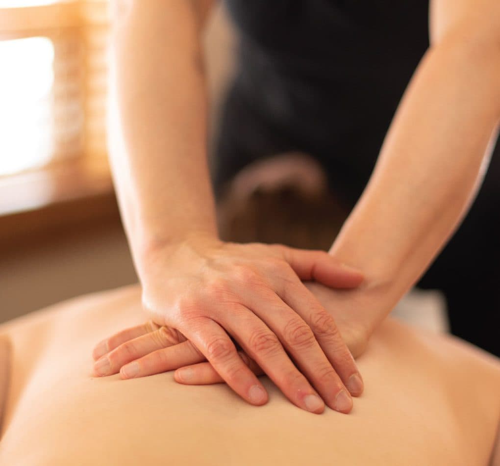 Close-up of massage therapist hands performing a massage