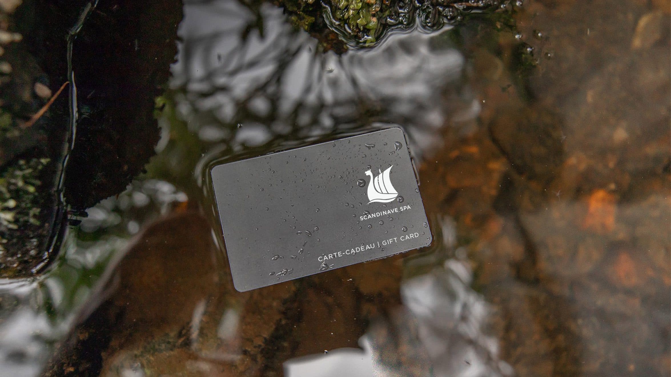 A Scandinave Spa gift card floats on the surface of the Diable's River at Mont-Tremblant.
